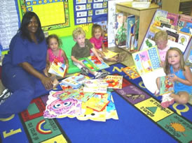 Delta State Child Development Center: From left-right, Brenda Dumas, teacher, Samantha Blake, Sherrod Cauthen, Kate McClain, Cash Miller, and Elizabeth Gray Havens students in the four year-old class look over some of the donated books.